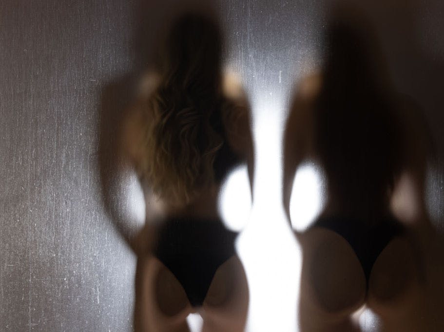 Silhouette of two women.