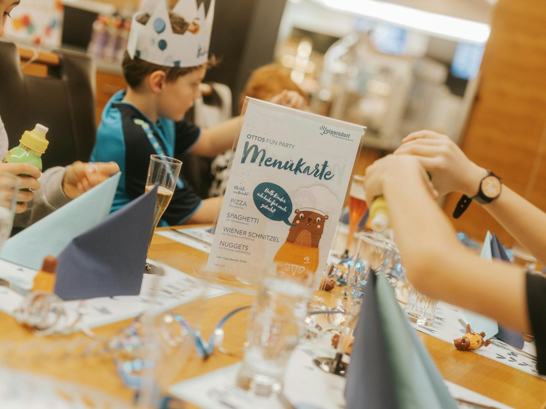 A colorful birthday table with a menu card in the middle