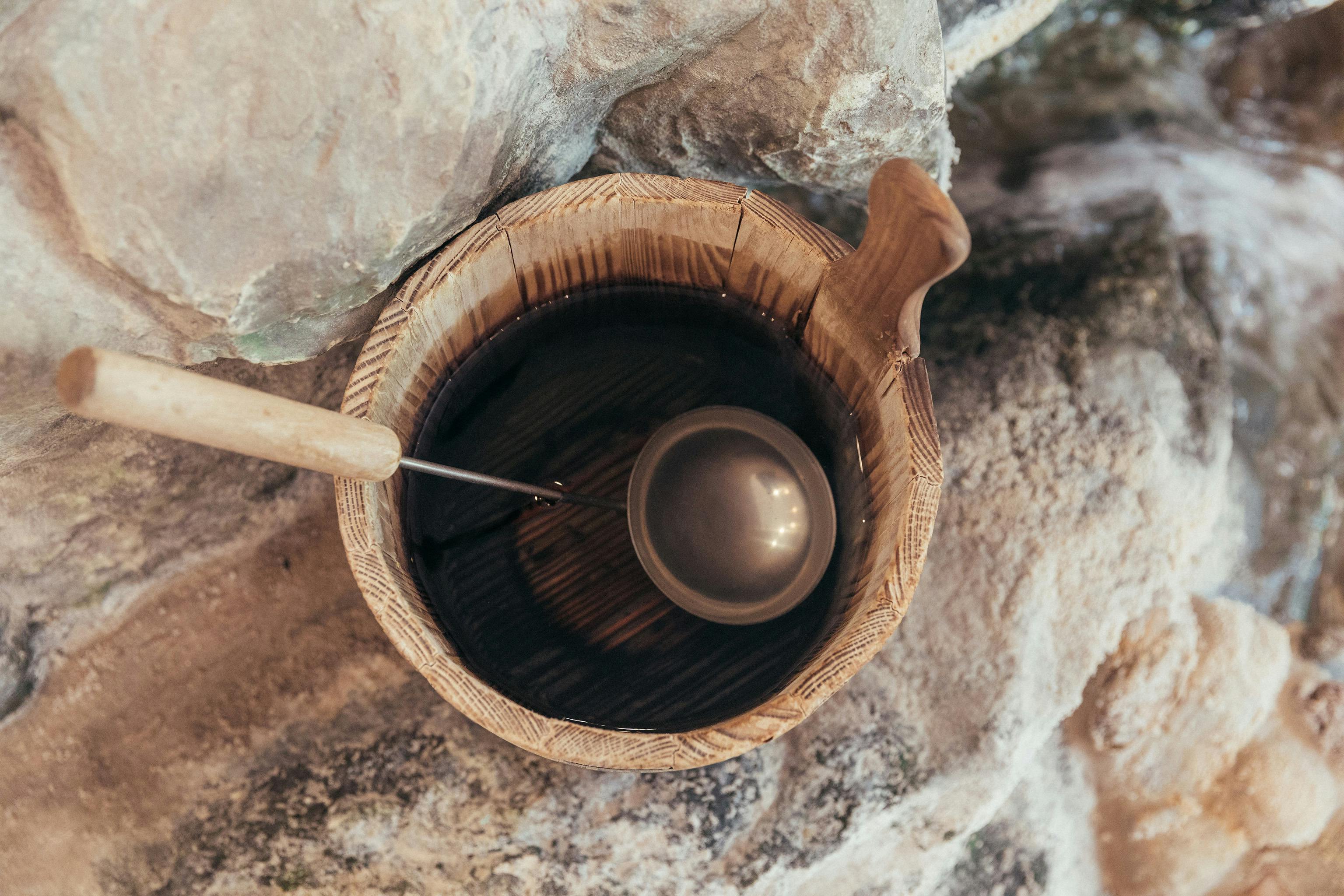 Pouring bucket with ladle from above.
