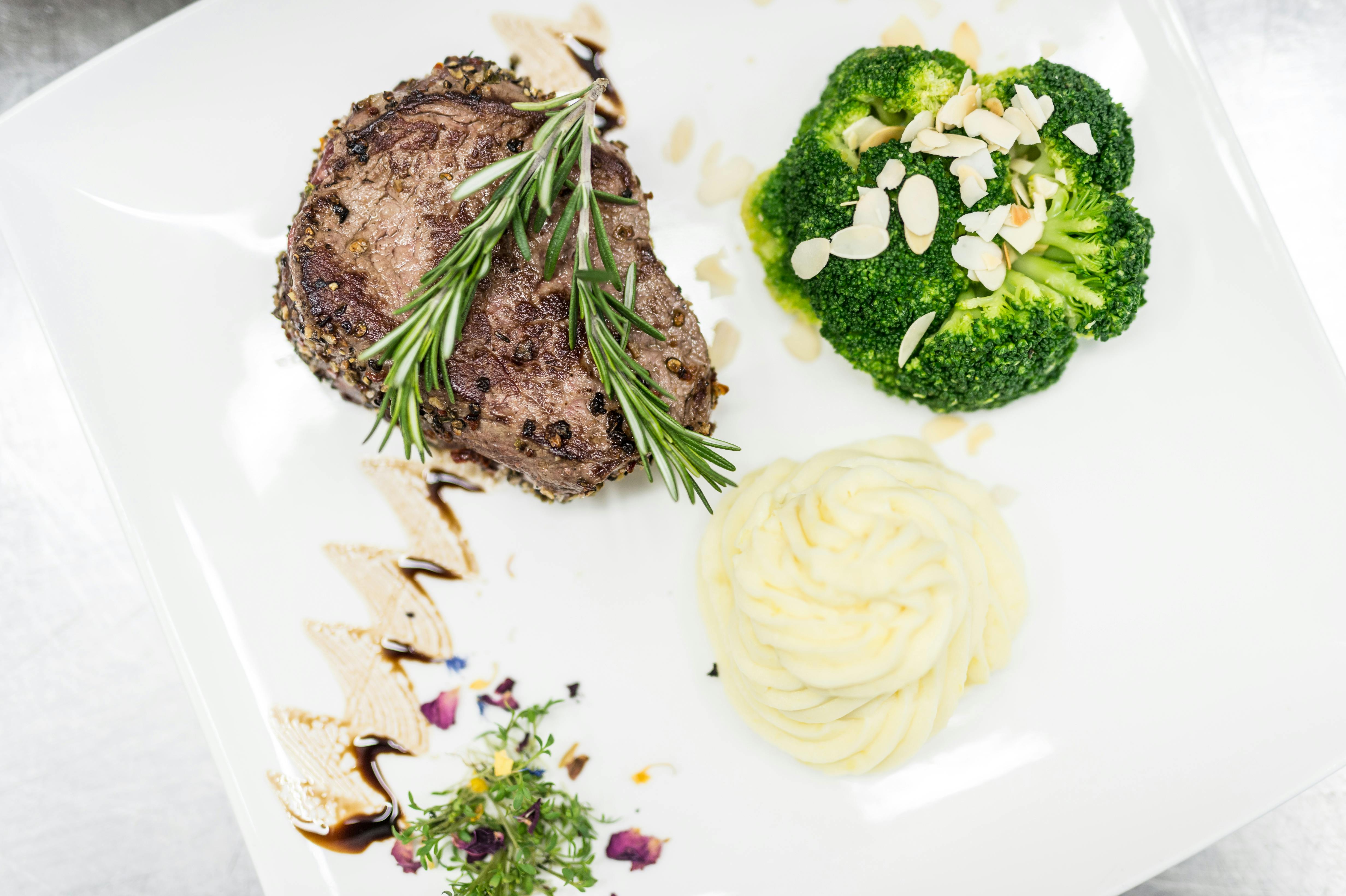 A plate with steak, broccoli and mashed potatoes.