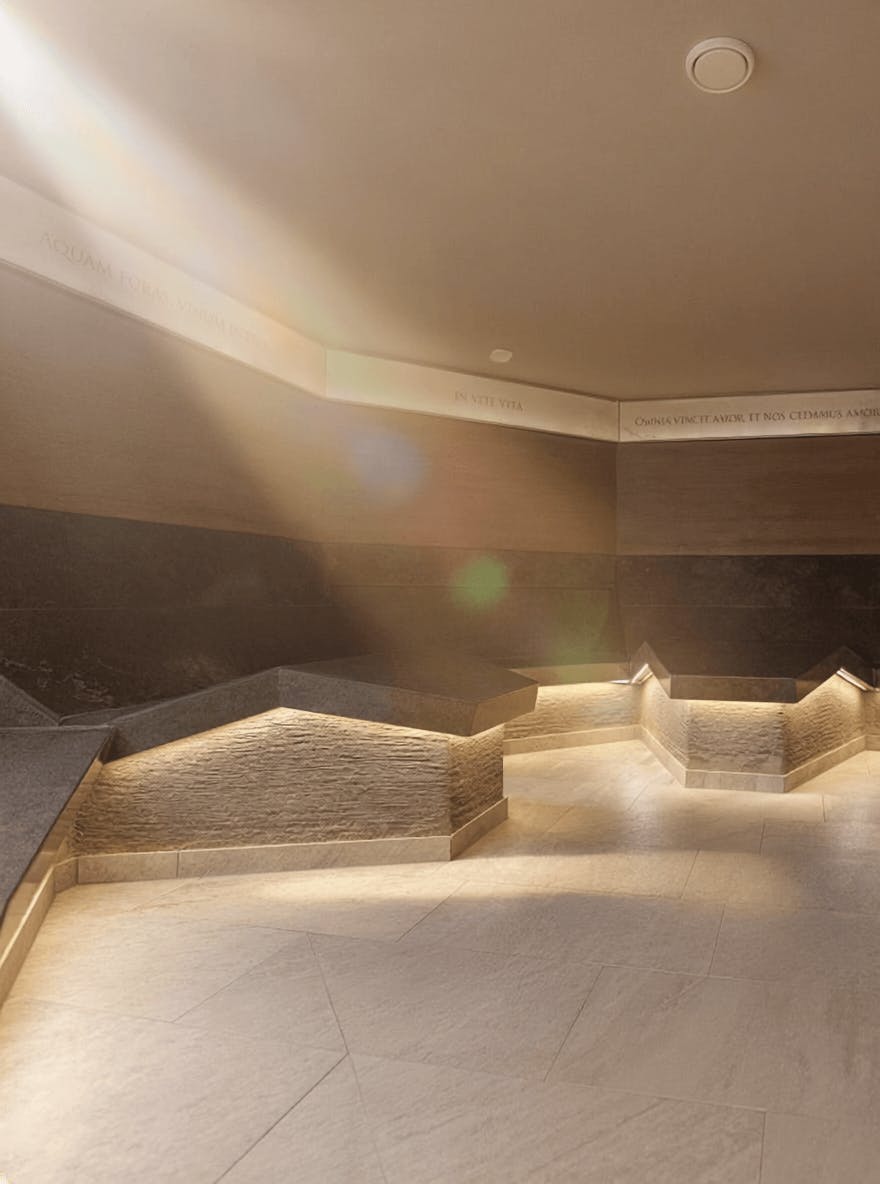 Innenraum mit polygonalen Sitzflächen und indirekter Beleuchtung in einem historischen Bad